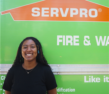 SERVPRO employee pictured in front of green background